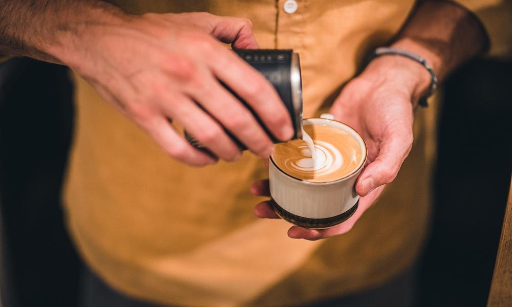 barista pouring latte art